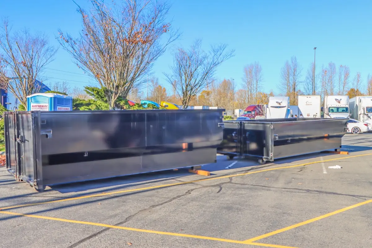 Professional dumpster rental service with roll-off container on residential driveway in Wallkill